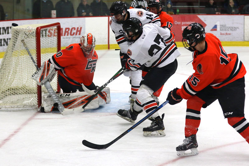 A Moorhead hockey goalie blocks the goal from the opposing team.