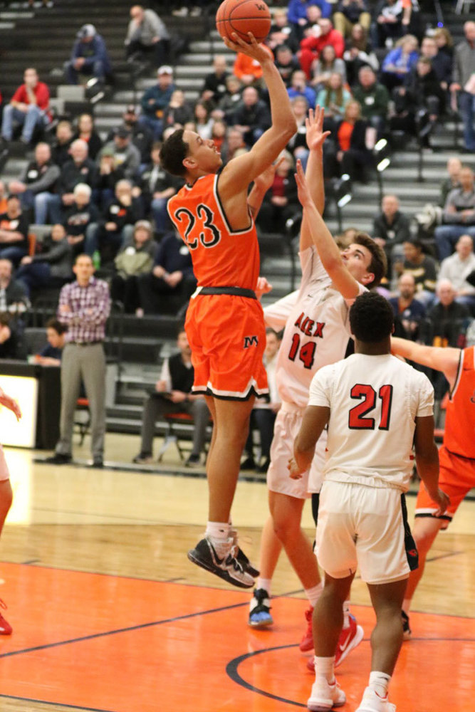 A picture of a Moorhead basketball player taking a jump shot. 