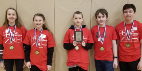 A photo of five students in matching red t-shirts and awards medals after a math competition