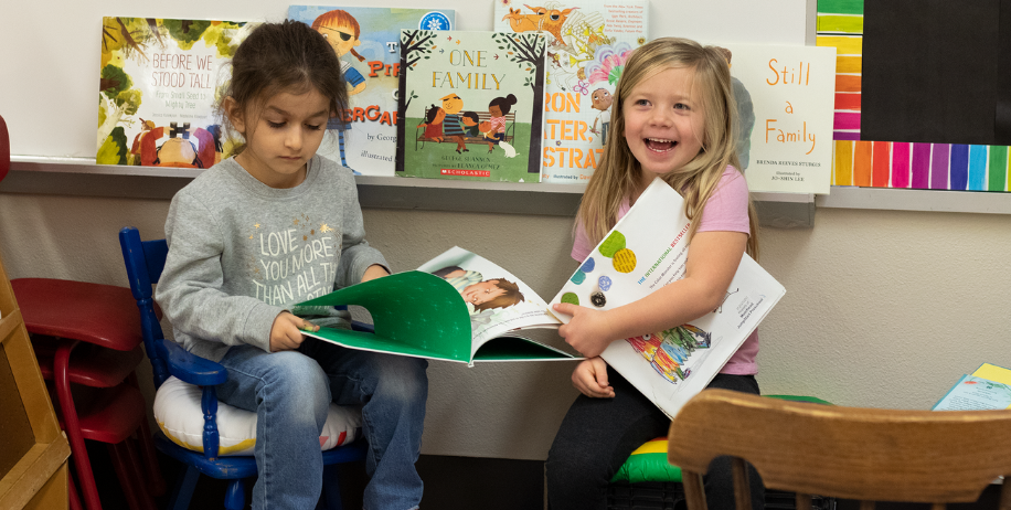 two students read books in a classroom