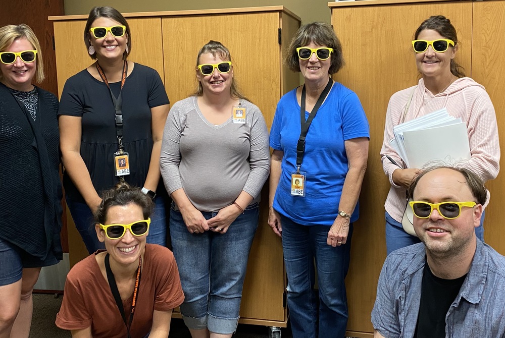Teachers and paraprofessionals in their yellow sunglasses