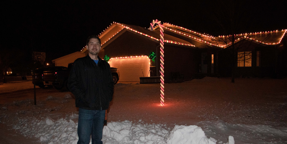 Brad Neznik pictured in front of a candy cane he made
