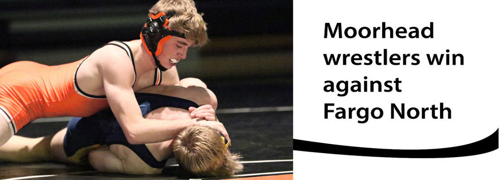 A Moorhead wrestler pins a Fargo North opponent during a wrestling match.