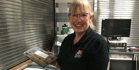 Cindy Noennig shows off some of the leftover frozen meals.