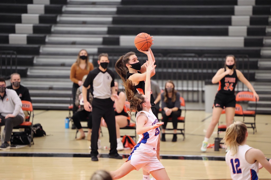 Girls Basketball player shoots the ball