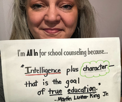 Counselor Holds Sign