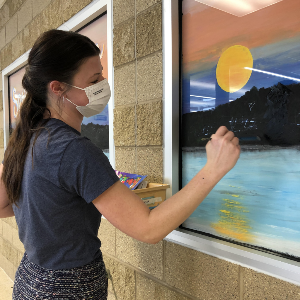 Art Teacher Jorddan painting a window at Horizon