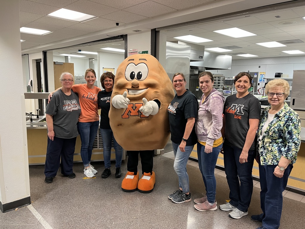 school lunch staff post with our mascot Spuddy