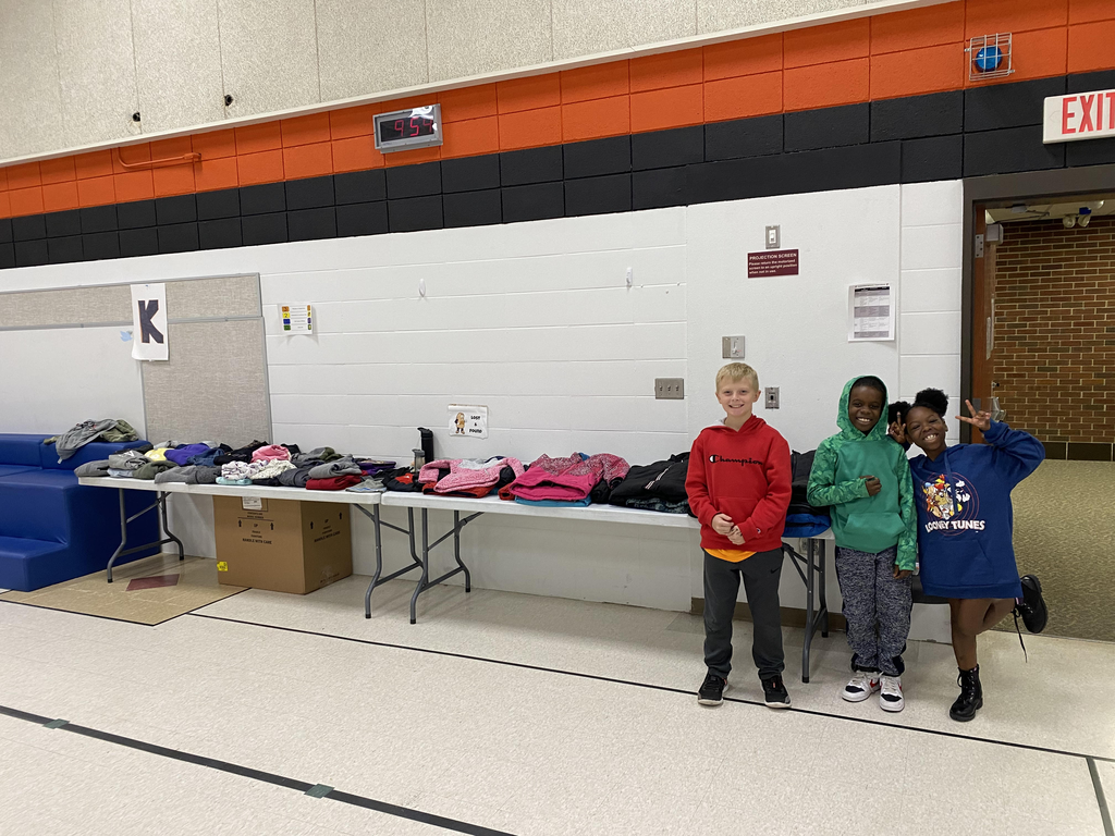kids standing by a table of lost and found items