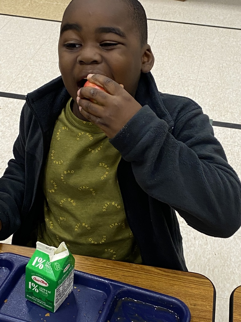 Student bites into an apple