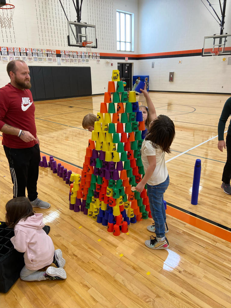 Students building a tower out of colorful cups