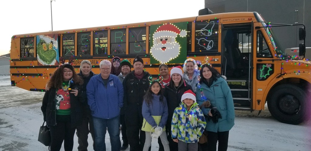 Transportation Team in front of bus with holiday lights