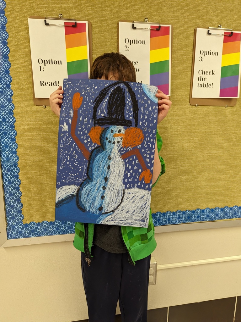 Student holding a snowman art piece