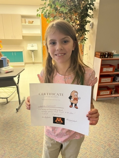 Student holding certificate