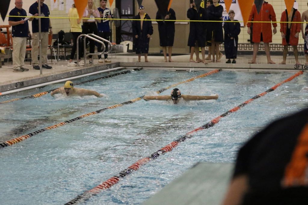 Boys Swim & Dive, swimmer races to the finish line. 