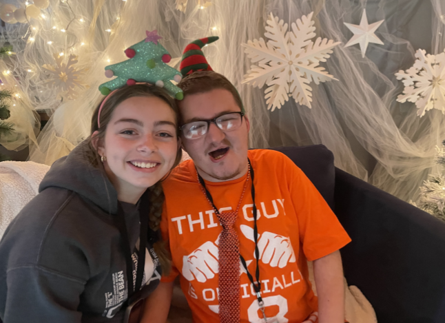 Two students smile for a picture in the winter selfie booth