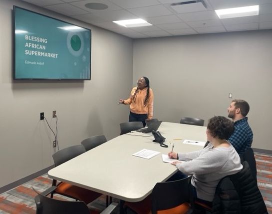 Student presents a slide deck to teachers