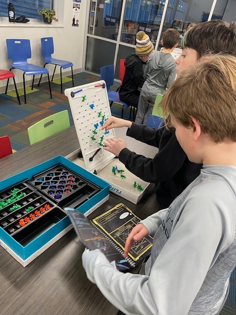 Two students work on a coding activity