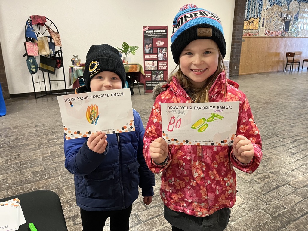 two kids hold up a picture they drew of their favorite snack