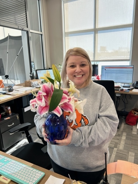 Admin assistant posed with flowers