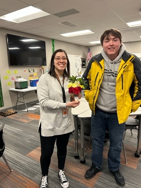 Student gives teacher a bouquet of flowers
