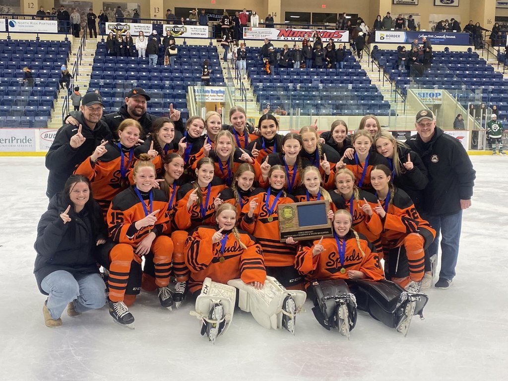 Girls hockey team takes a photo with their section trophy