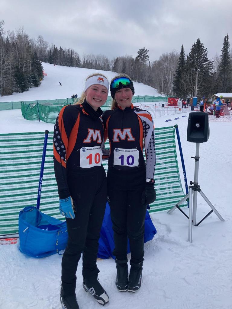 two nordic ski teammates pose for picture
