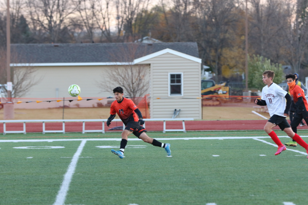 Revar Qaqos makes an assist during the first game in the section tournament. Photo credit: Renee Grover 