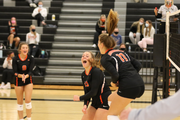 Riane Mohagen (9), Rosie Anderson (13) and Bryn Stumo (11) celebrate together while playing one of their first games of the season. Photo Credit: Renee Grover. 