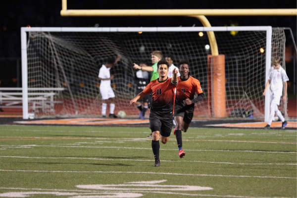 Saif Allawi (11) and Jibriel Gedo (7) celebrate Allawi's goal at a recent home boys soccer game. Photo Credit: Bill Grover