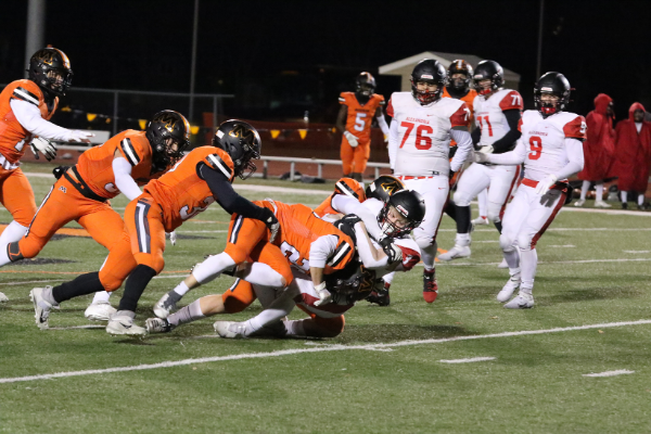 Moorhead's entire defense was named the defensive player of the game in the win against Alexandria on Nov. 20. Keanan Wendt (28) goes in for the tackle with his teammates close behind. 