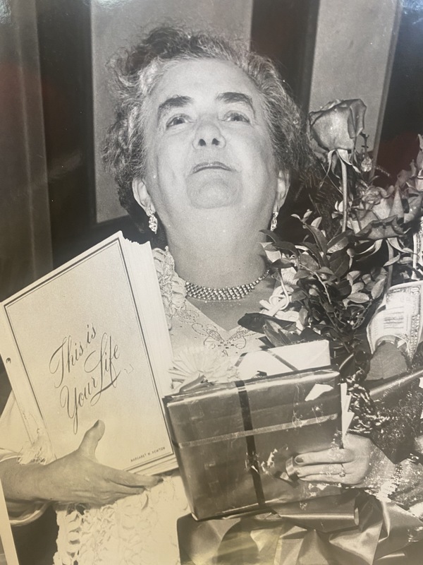 Margaret Newton pictured with her scrapbook at her retirement party.